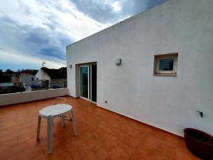 Habitación blanca con mesa y ventana en Villa Solimar, en L'Ampolla