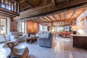 a living room filled with furniture and a dining room at La ferme d'octave in Dosches