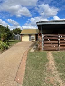 a house with a driveway next to a garage at Clermont Guest House - Pet friendly in Clermont