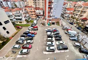 an aerial view of a parking lot with cars at Homestay Mark - DOUBLE BED ROOM - shared bathroom in Budva +1 photo
