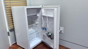 an open refrigerator with drinks and water bottles in it at Oceanview Property in West Vancouver