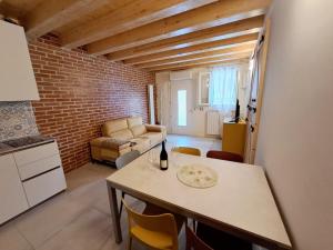 a kitchen and living room with a table and a couch at Ca Jole in Burano