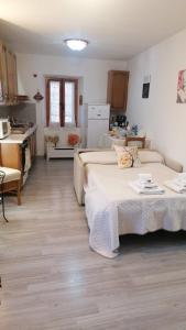 un soggiorno con 2 letti e una cucina di La Casetta di Mimmi a Castel Viscardo
