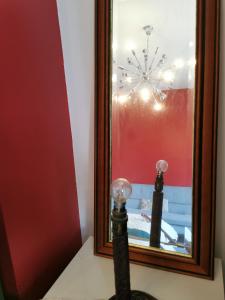 a mirror with a reflection of a table in a room at Large Double Room with Private Toilet and Shower in Southend-on-Sea