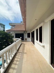 a balcony of a house with a white railing at Blooming Hill Boutique Suites in Pattaya South