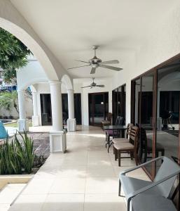 a patio with chairs and a ceiling fan at Blooming Hill Boutique Suites in Pattaya South