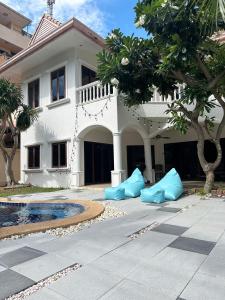 a white house with blue inflatables in front of it at Blooming Hill Boutique Suites in Pattaya South