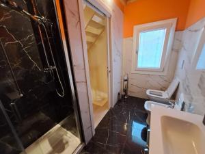 a bathroom with a shower and a toilet and a sink at Ca Jole in Burano