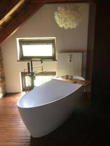 a white bath tub sitting in a room at Záhradný domček in Levoča