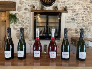 vier flessen wijn zittend op een tafel met wijnglazen bij Gite du pommerat in Villenauxe-la-Grande