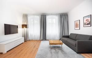 a living room with a couch and a tv at 2-Room Apartment near Messe and Lietzensee in Berlin