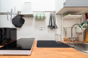 a kitchen with a sink and a laptop on a counter at 2-Room Apartment near Messe and Lietzensee in Berlin