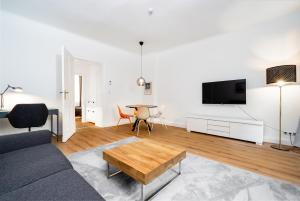a living room with a couch and a table at 2-Room Apartment near Messe and Lietzensee in Berlin