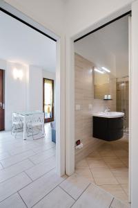 a bathroom with a sink and a table at Xenia Apartments - New and Bright Urban Housing in Milan