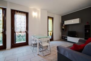 a living room with a table and a couch at Xenia Apartments - New and Bright Urban Housing in Milan
