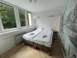 Posteľ alebo postele v izbe v ubytovaní LTC Apartments Wzgórze św Maksymiliana + 1 fotografia