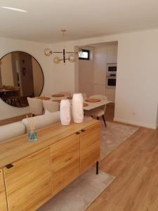 a living room with a couch and a mirror at Beachfront Apartment in Vila Praia de Âncora