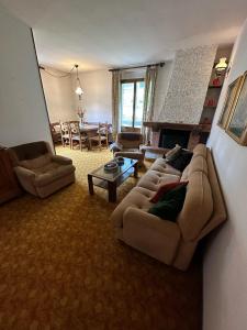 a living room with two couches and a fireplace at Bilocale in centro ad 1 km dalla pista in Giustino