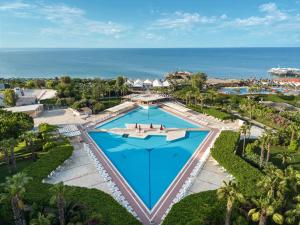 an overhead view of a pool with the ocean in the background at Kaya Belek in Belek