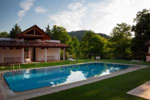 a swimming pool in the yard of a house at Bellosguardo Resort in Modigliana