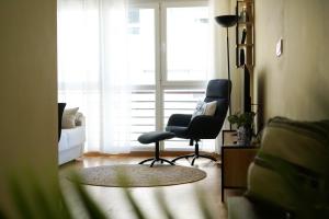 a living room with a chair and a window at ALMA DE MALPICA apartamento nuevo en el centro in Malpica
