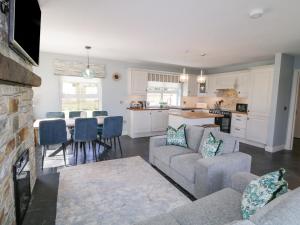 a kitchen and living room with a couch and a table at The Haven in Falcarragh