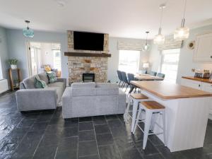 a kitchen and living room with a couch and a table at The Haven in Falcarragh