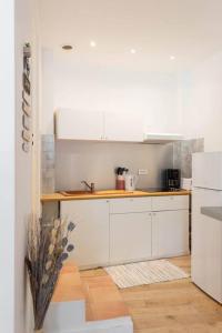 a kitchen with white cabinets and a counter top at Magnifique studio à Bompard proche de la plage in Marseille
