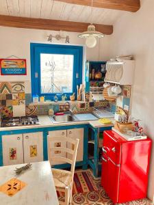 a kitchen with a red refrigerator and a red freezer at Casa Colore Attic in Castellammare del Golfo