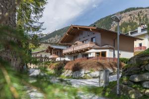 a house in the mountains next to a river at Ferienhaus Florianiweg in Bad Gastein
