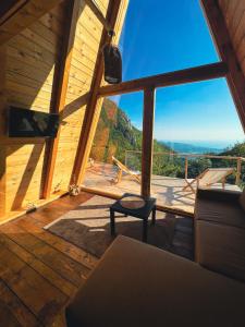 a living room with a large window with a view at Horizon Lodge Medurec in Ulcinj