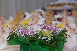 a vase filled with flowers on a table at Bellevue del Golfo Hotel & Spa in Sferracavallo