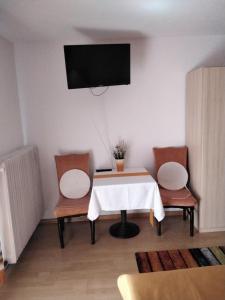 a room with a table and two chairs and a tv at Mühlwinkler Hof in Bergen