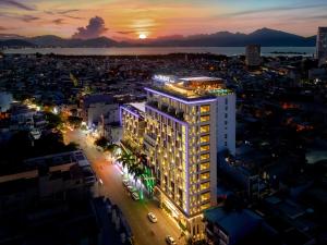 a lit up building in a city at night at New Orient Hotel Da Nang in Danang