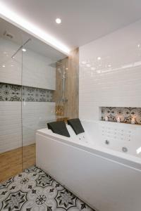 a white bath tub in a bathroom with a shower at Siedem Drzew in Biskupice
