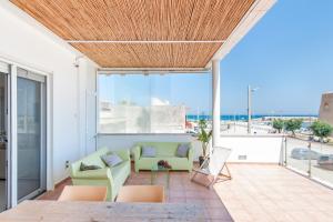 a living room with a couch and chairs on a balcony at THE VIEW B&B, terrace & more in San Foca +47 photos
