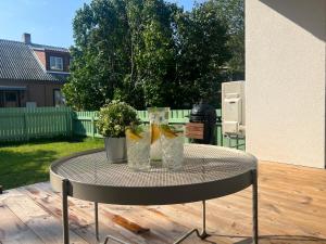 a table with two vases on it on a patio at Kuressaare Pikk Apartment in Kuressaare