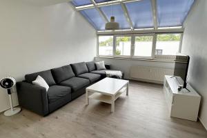 a living room with a couch and a table at Ferienwohnung an der Messe *inkl. Garage* in Erfurt