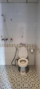 a bathroom with a toilet and a shower at KANPAI HOTEL in Patong Beach