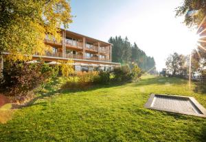 a building in the middle of a field with a building at Naturhotel Bauernhofer in Heilbrunn