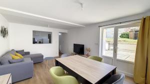 a living room with a table and a couch at Appartement Criel-sur-Mer in Criel-sur-Mer