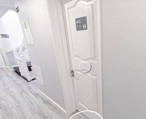 a bathroom with a door with a sign on it at WE ARE HOSTEL in Póvoa de Varzim +48 photos