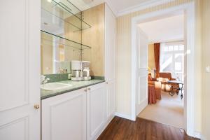 a bathroom with a sink and a mirror at Strandhotel Sylt Westerland in Westerland