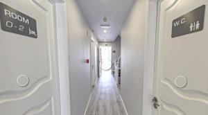 a hallway with white walls and a white door at WE ARE HOSTEL in Póvoa de Varzim