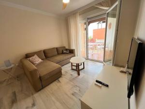 a living room with a couch and a table at PUSHE Playa Granada Beach & Golf 17 in Motril