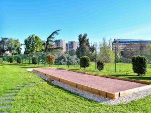 a park with a large sandbox in the grass at Novotel Paris Créteil Le Lac in Créteil