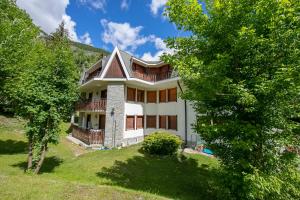 a large white house on a hill with trees at Asteria 29 skiing nearby - Happy Rentals in Bardonecchia