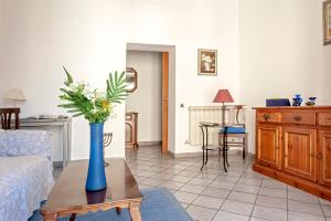 a living room with a vase of flowers on a table at La casa di Chiara in Livorno