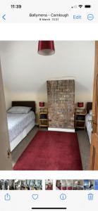 a bedroom with a bed and a brick fireplace at Ebenezer in Carnlough