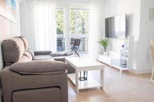 a living room with a couch and a table at Las Estrellas 301 in Torremolinos